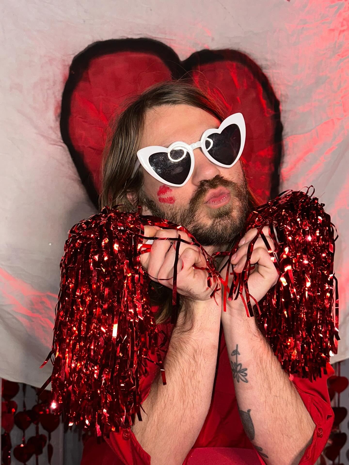 Performer with heart glasses and red tinsel